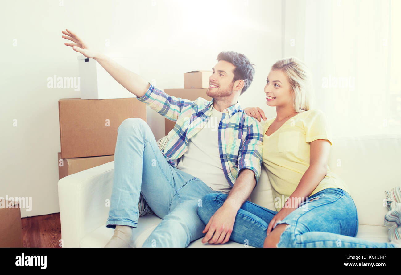 couple with boxes moving to new home and dreaming Stock Photo - Alamy