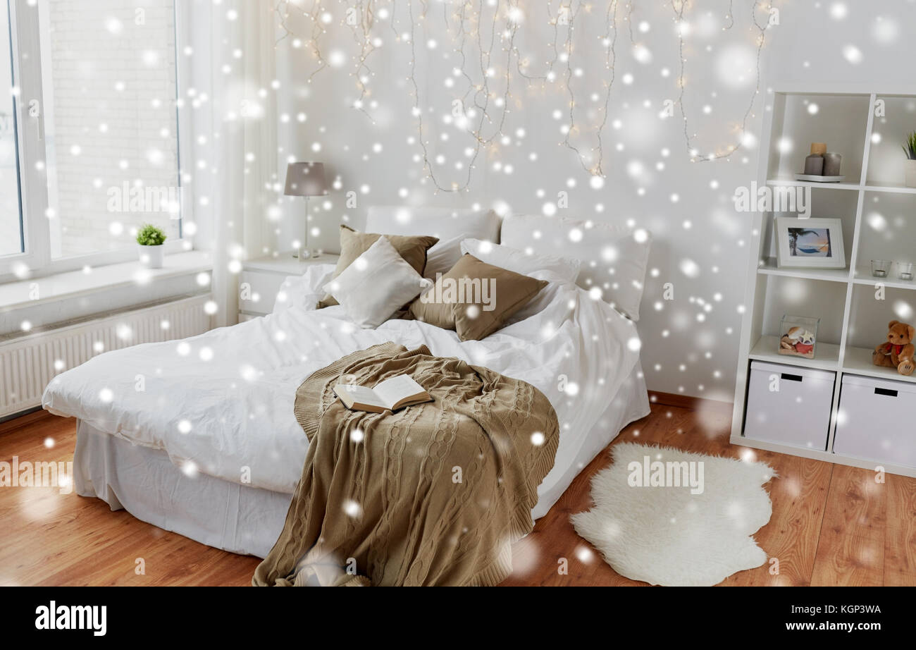 bedroom with bed and christmas garland at home Stock Photo