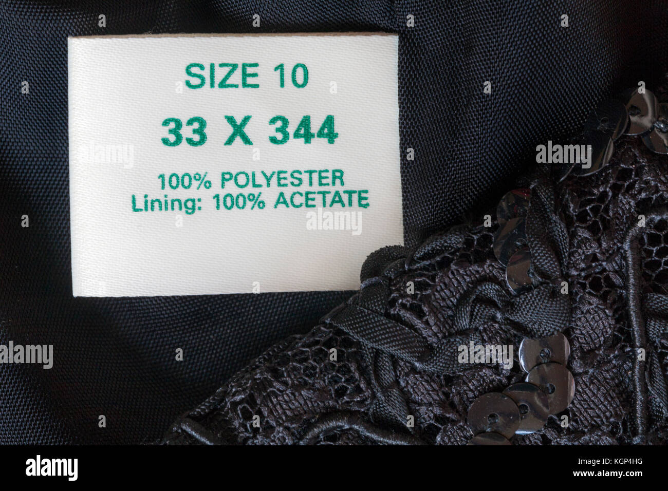 100% polyester lining 100% acetate label in woman's sequinned little black dress size 10 Stock Photo