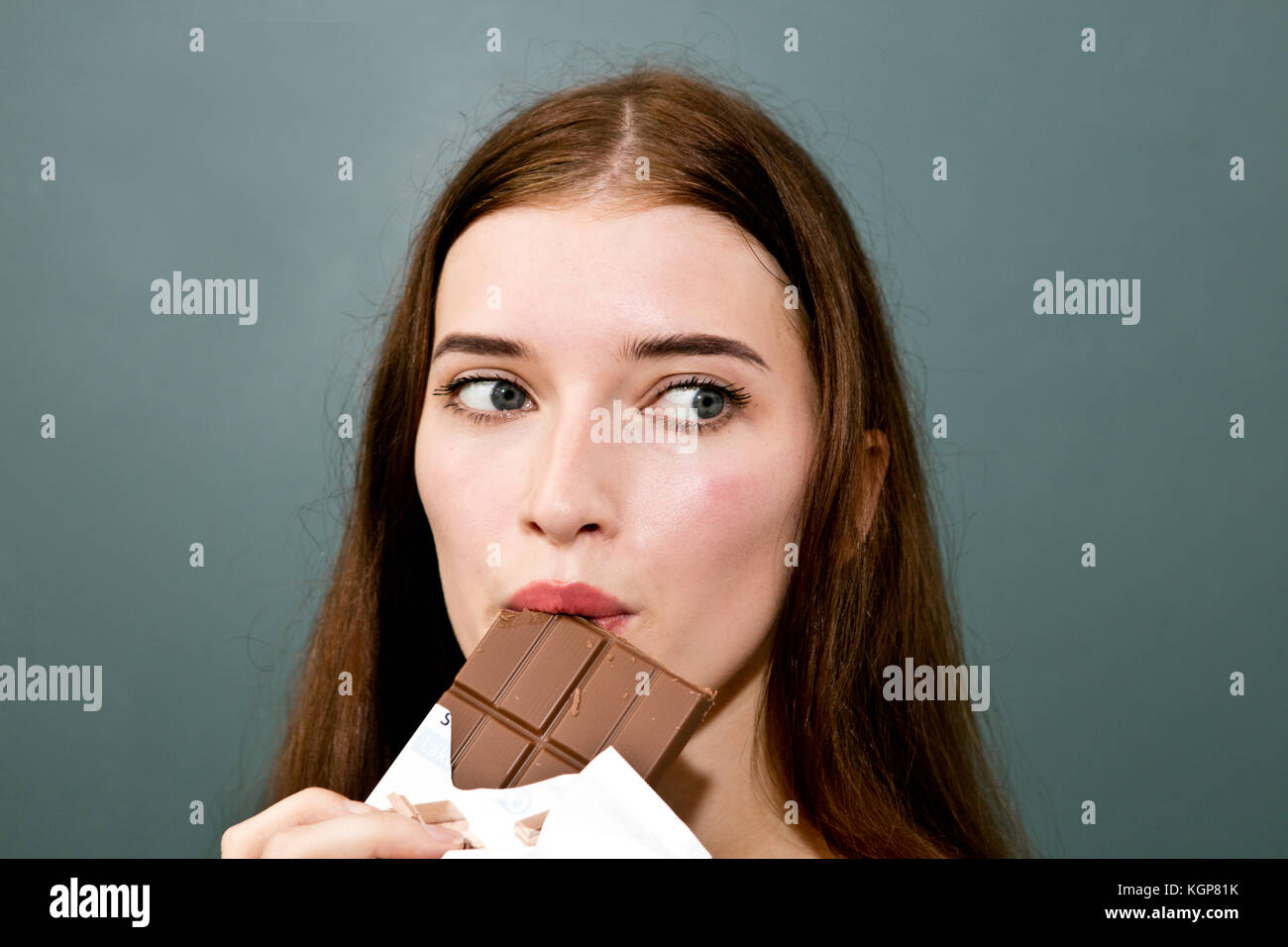 Close-up girl eating chocolate Bar Stock Photo