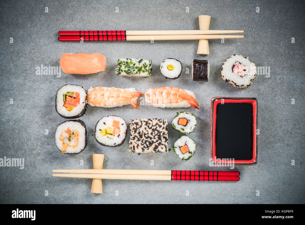 Sushi on stone or concrete slate with chopsticks. Stock Photo