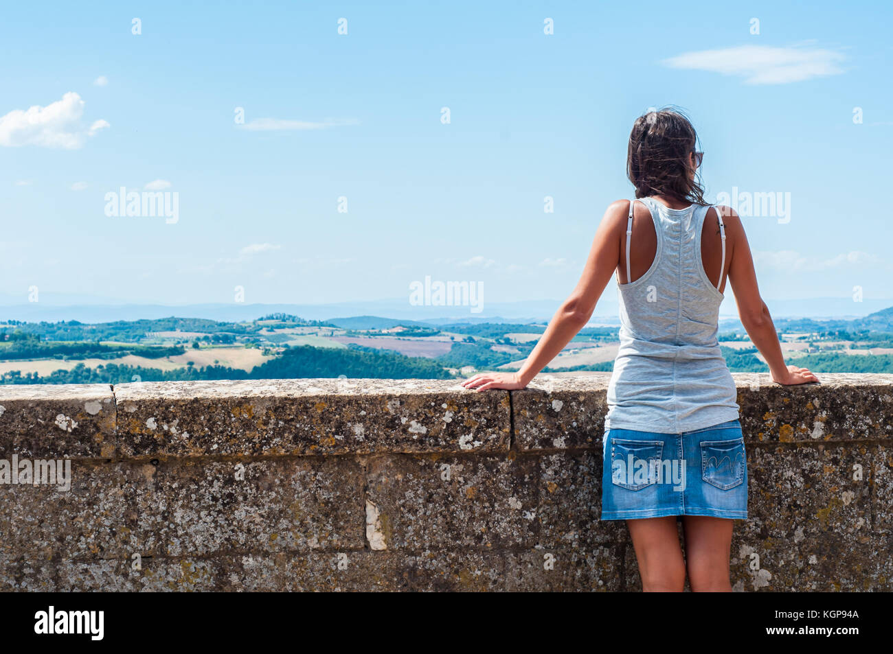 Woman admiring the summer Italian landscape in Montepulciano, Tuscany, Italy. Stock Photo