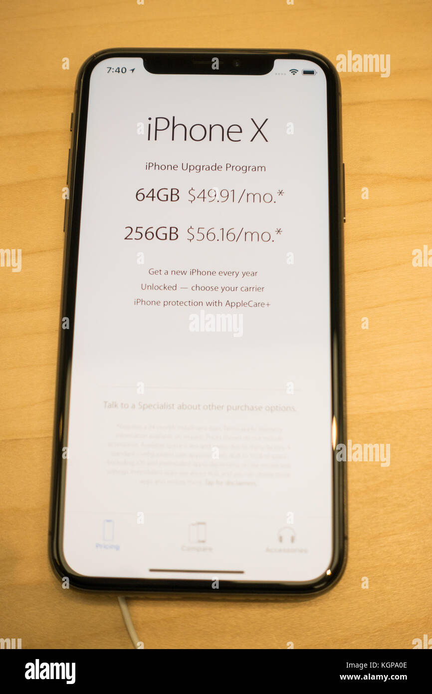 New iPhone X on a display at the Apple Store with pricing displayed on a screen Stock Photo