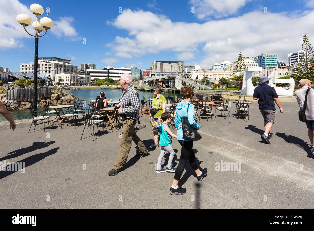 WELLINGTON, NEW ZEALAND - MARCH 1, 2017: People walk along the seafront promenade in Wellingtion on a sunny summer day in New Zealand capital city. Stock Photo