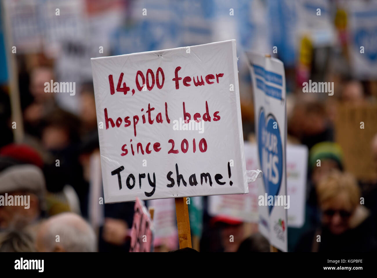 Fewer hospital beds since 2010 placard during Our NHS protest
