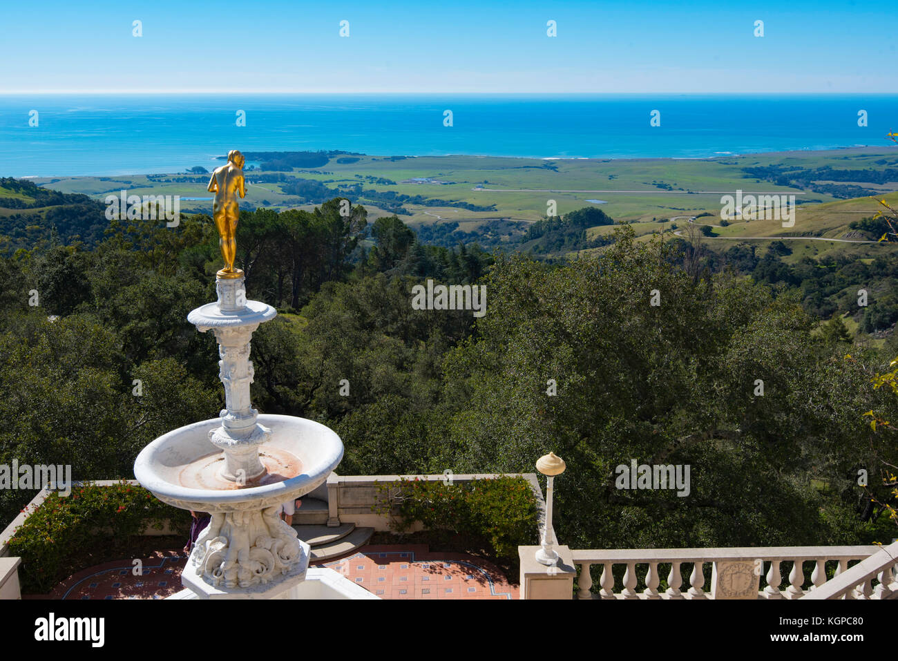 Looking down to San Simeon and the west coast of California past a statue at Hearst Castle, USA Stock Photo