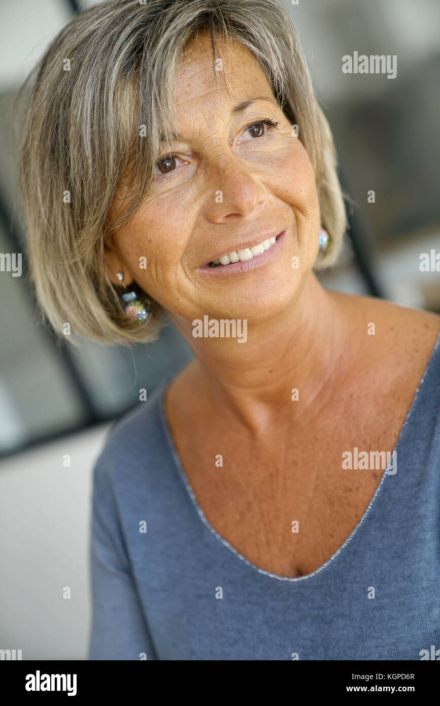 Standing woman in blue shirt hi-res stock photography and images - Alamy