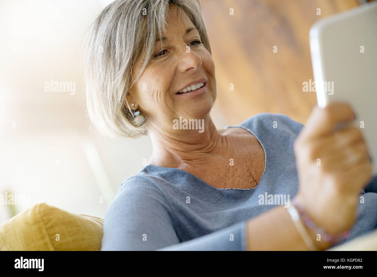 Senior woman in sofa hi-res stock photography and images - Alamy
