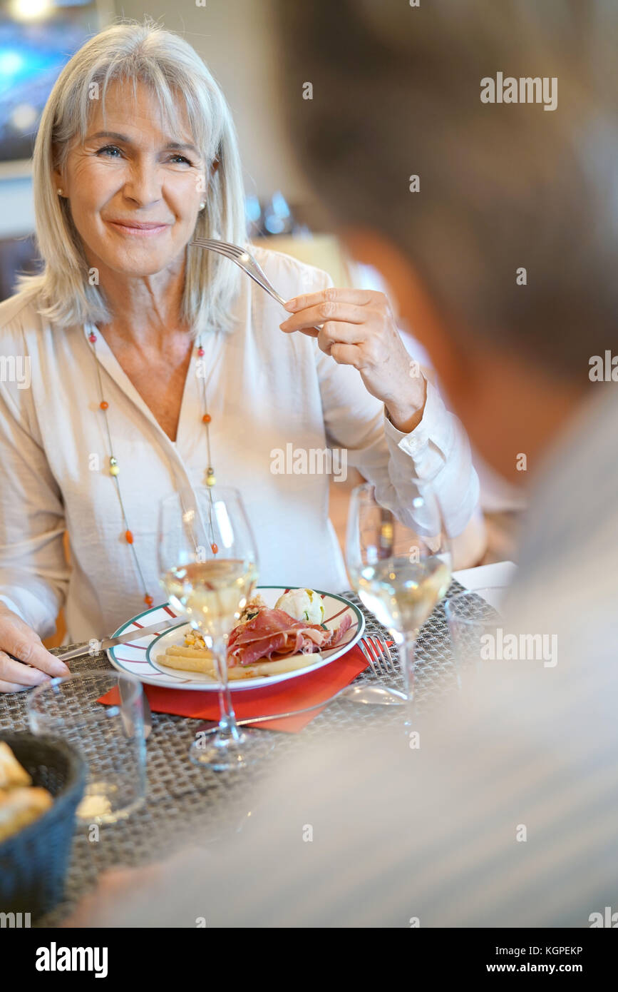 Senior couple sitting at restaurant table for dinner Stock Photo