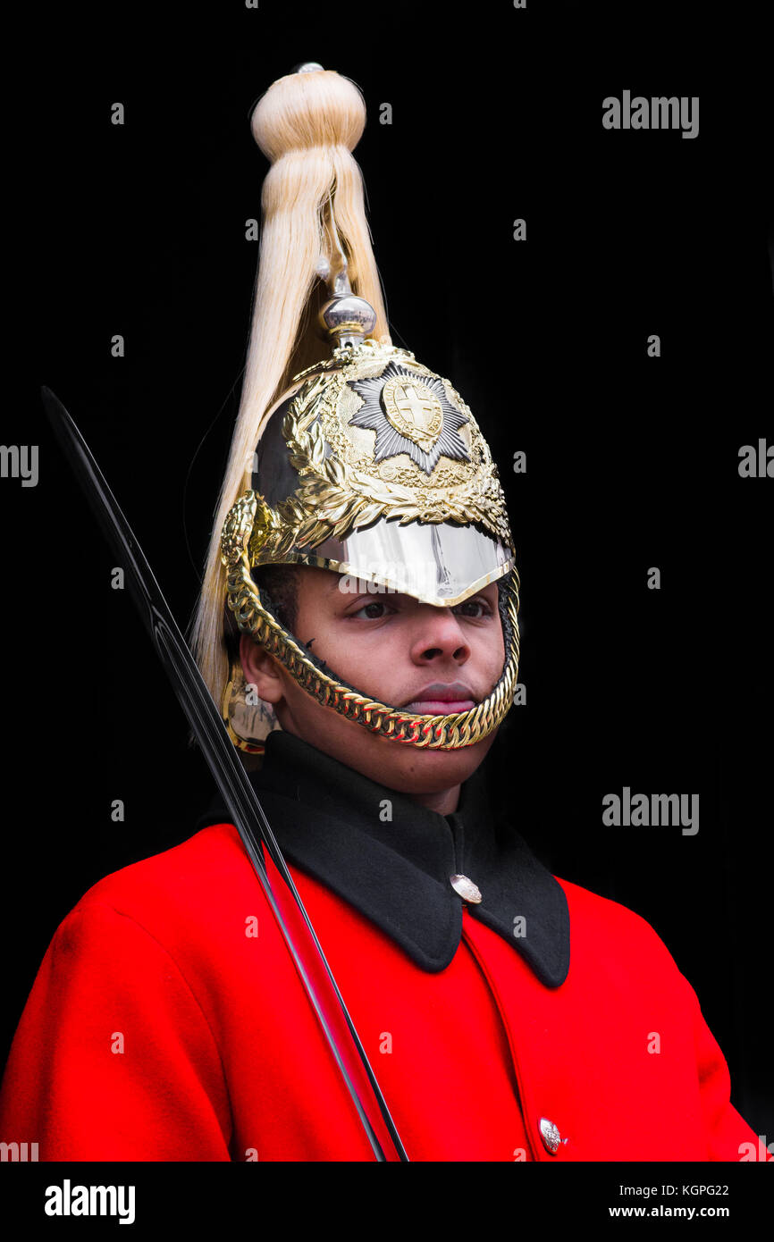 One of the queen's mounted life guards with sword on duty outside the horse guards building on