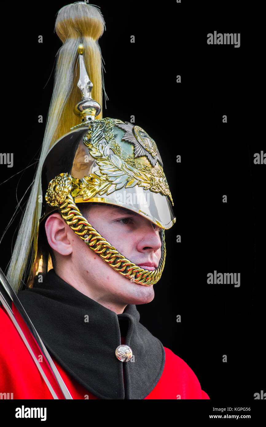 One of the queen's mounted life guards with sword on duty outside the horse guards building on
