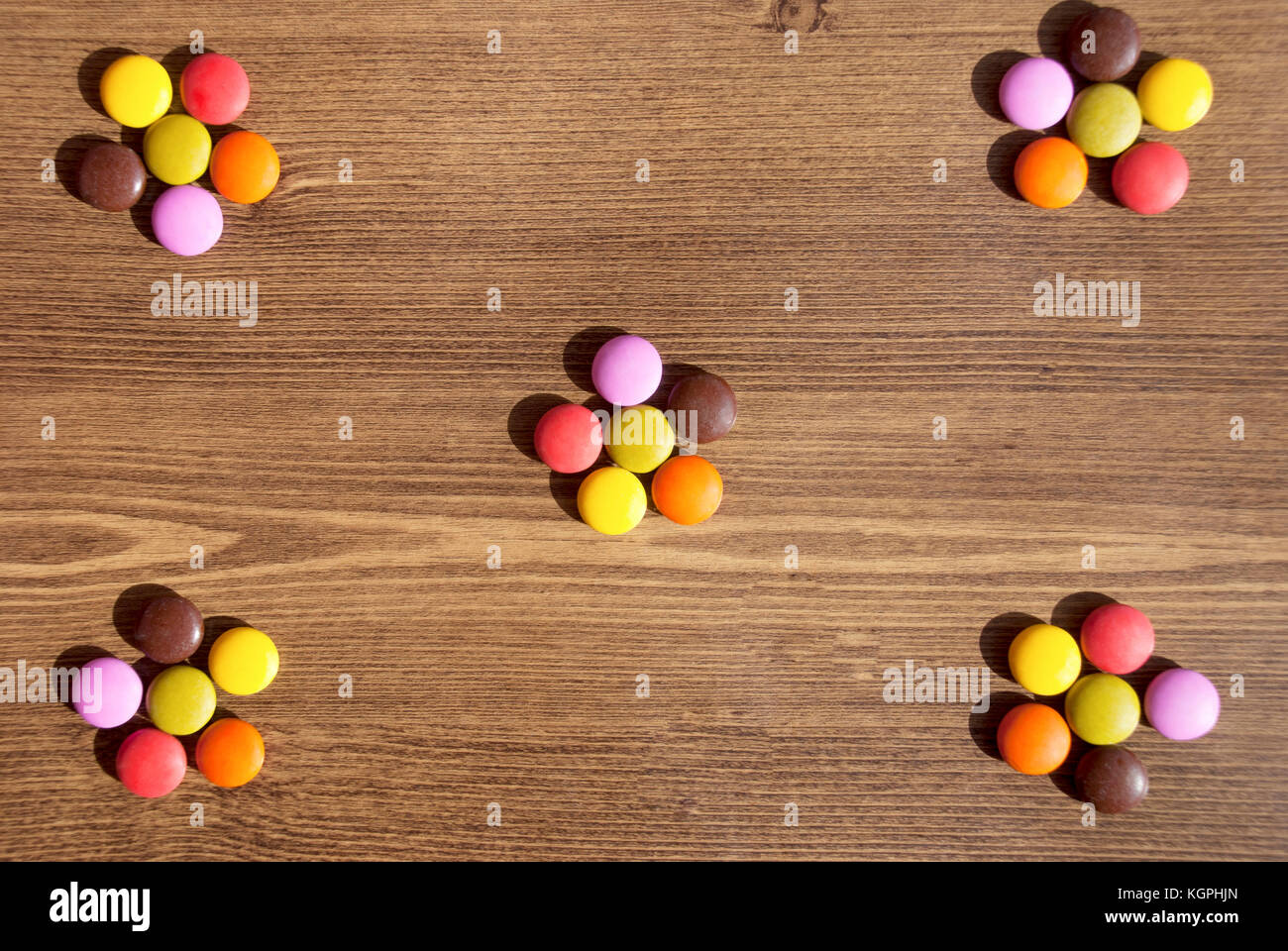 Flower-shaped of colorful candies for bacgrounds on theWooden Table Stock Photo