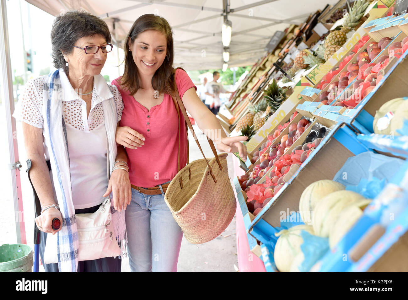Senior woman going to grocery store with help of carer Stock Photo - Alamy