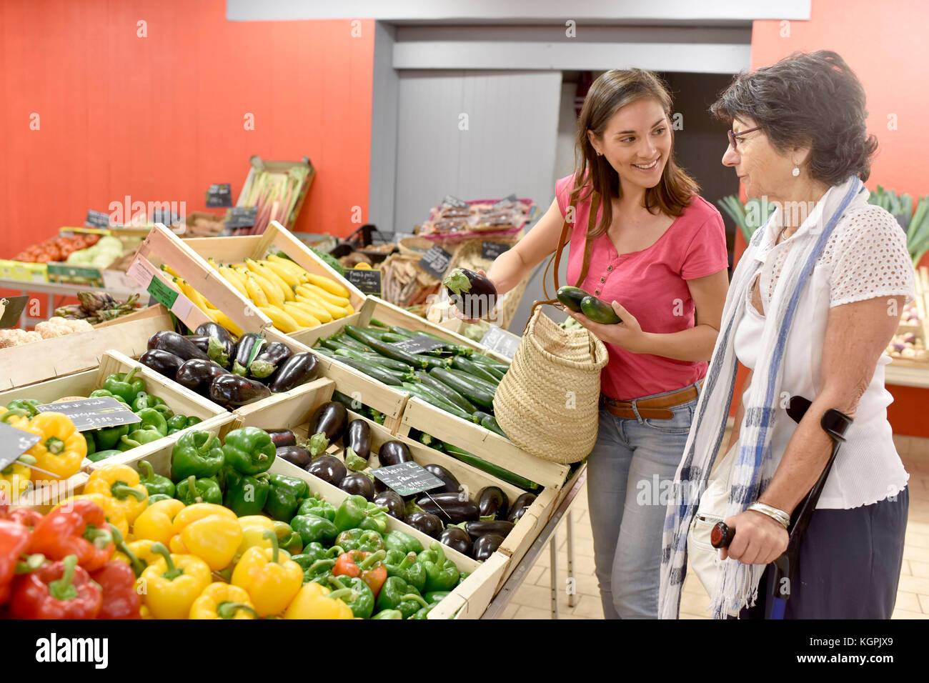 Senior woman going to grocery store with help of carer Stock Photo - Alamy