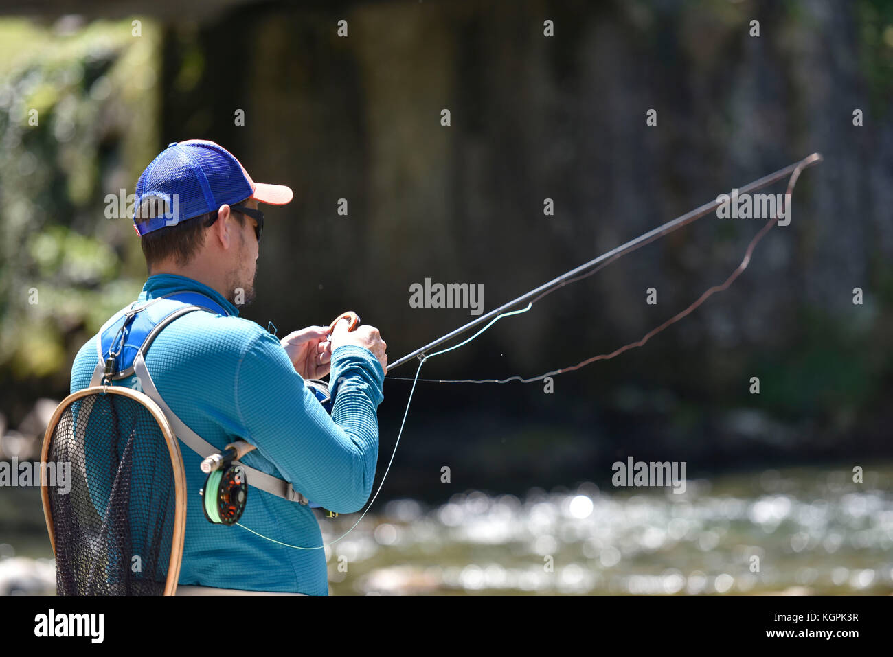 Fly-fisherman preparing fishing rod Stock Photo