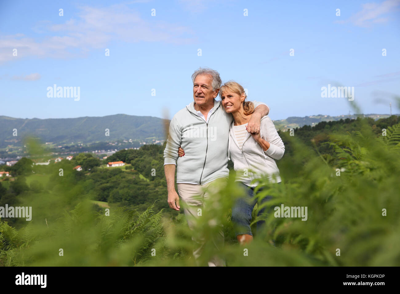 Senior couple walking in countryside, scenery Stock Photo