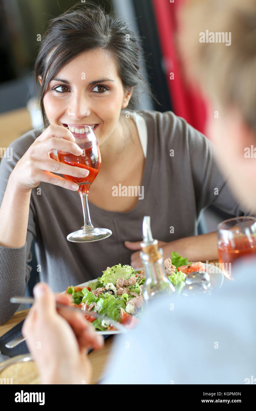 Young woman in restaurant eating lunch with boyfriend Stock Photo
