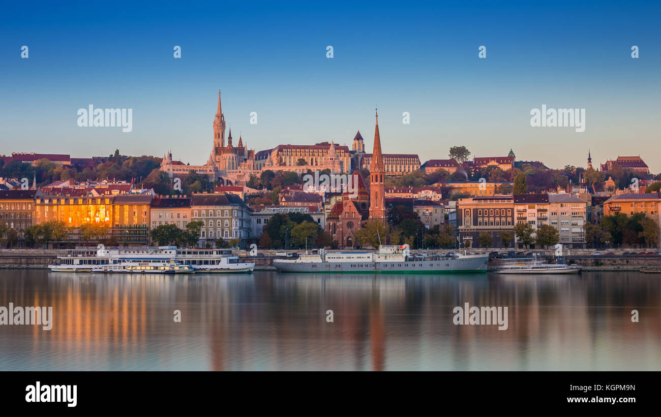 Budapest, Hungary - Sunrise view of Buda side of Budapest with the Buda Castle, St. Matthias church and the Fisherman's Bastion with old ships on Rive Stock Photo