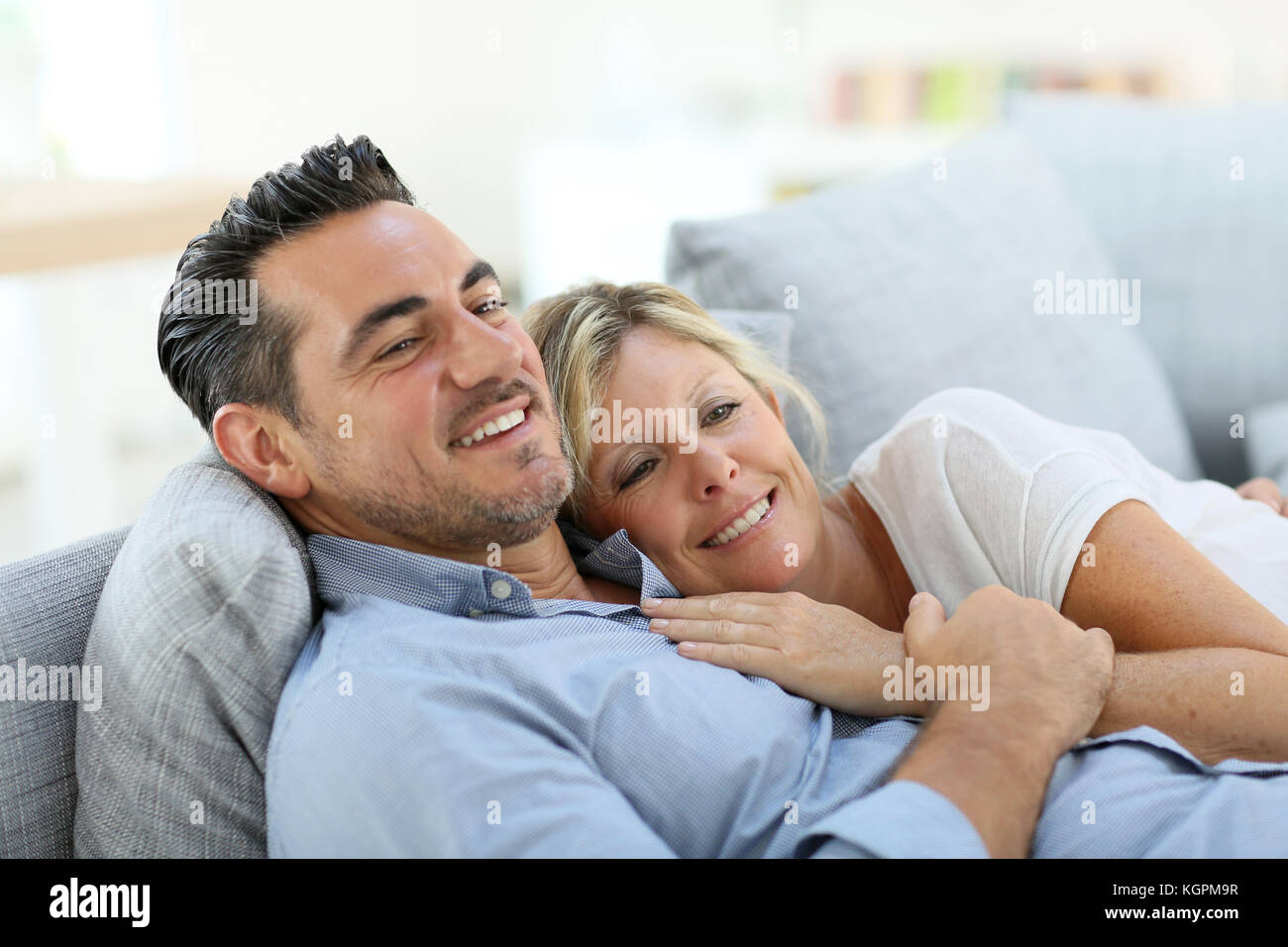 Mature couple relaxing in sofa at home Stock Photo - Alamy