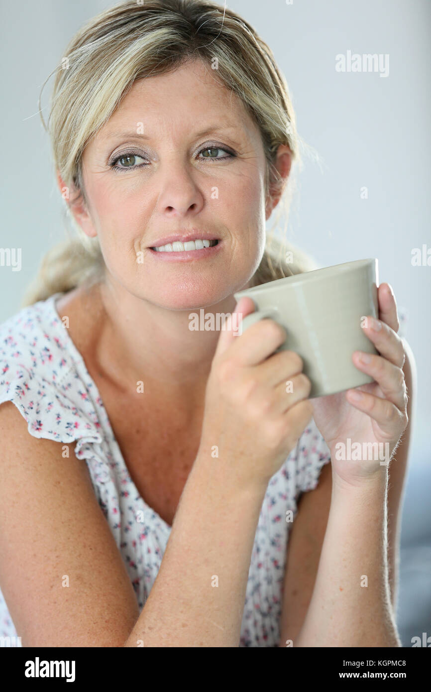 Relaxed woman having hot tea at home Stock Photo Alamy