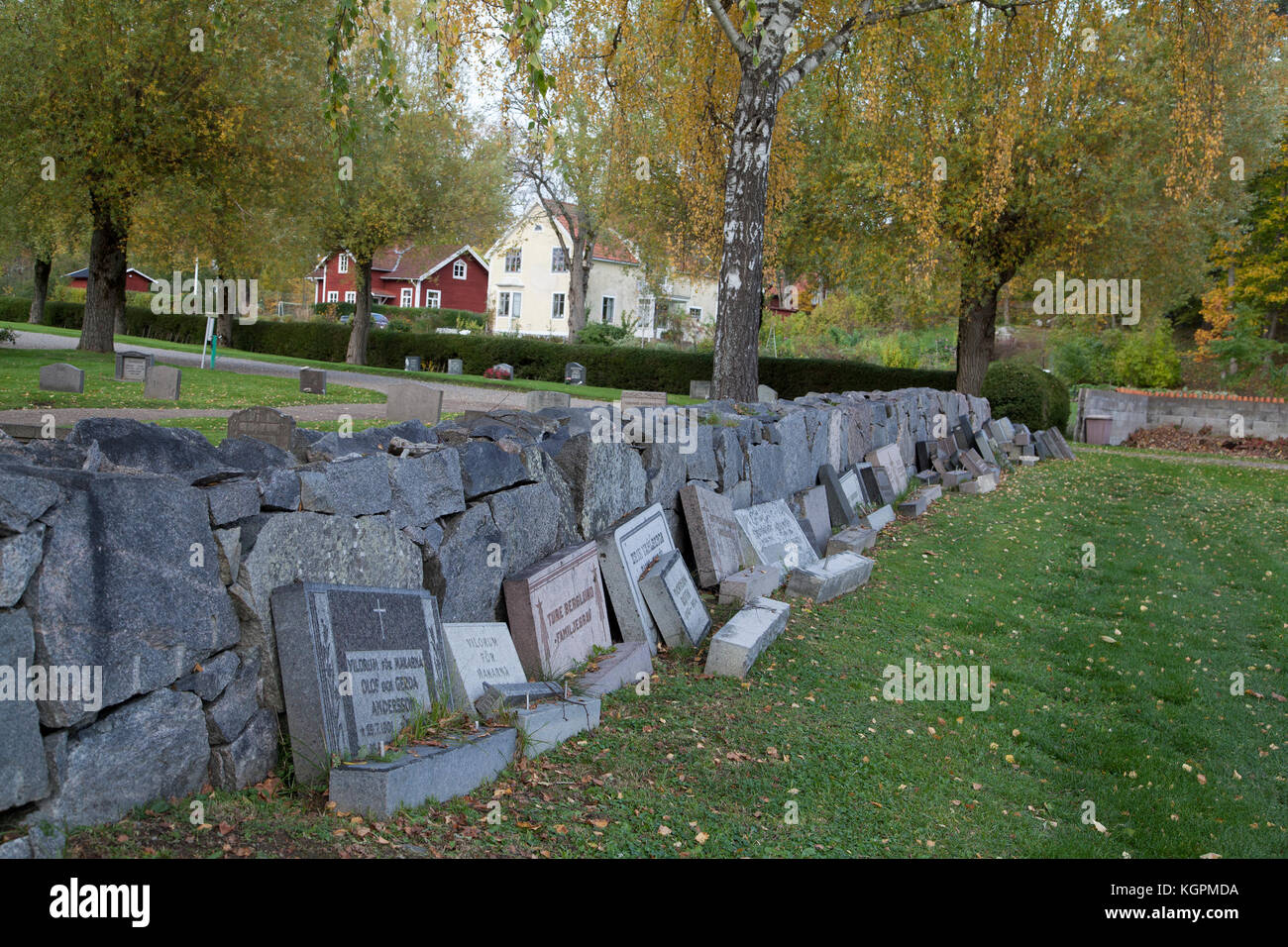 GRAVESTONES from completed graves have been set against the cementery wall waiting for reuse Stock Photo
