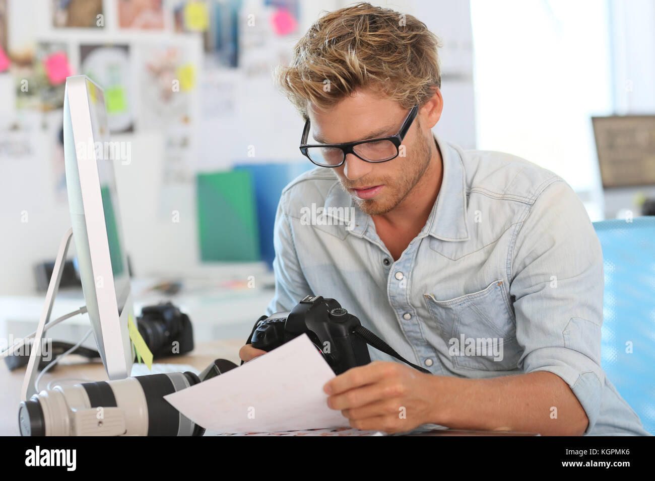 Portrait of young photographer reporter in office Stock Photo - Alamy