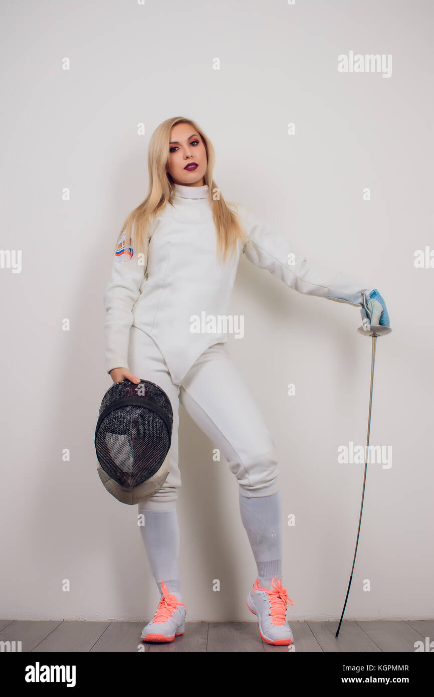 woman wearing fencing suit practicing with sword against grey vignette girl  Stock Photo - Alamy