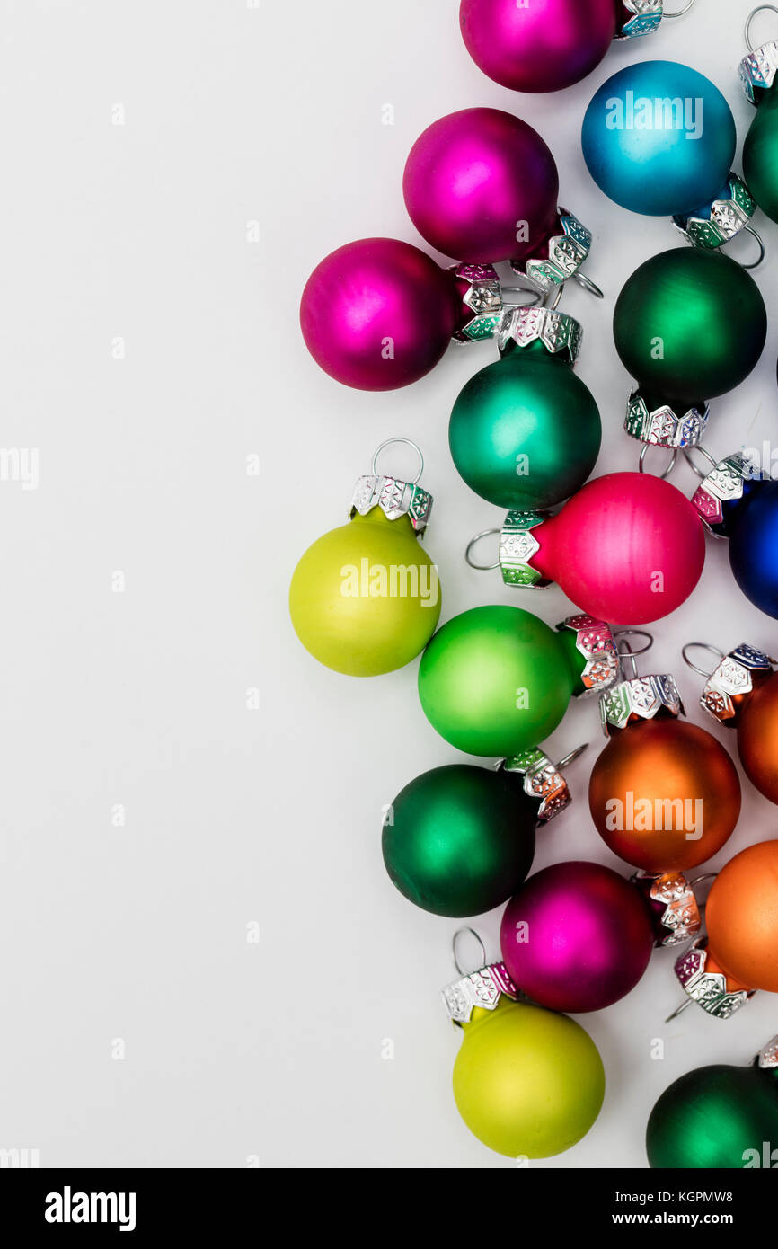 Festive Christmas baubles on a plain white background Stock Photo