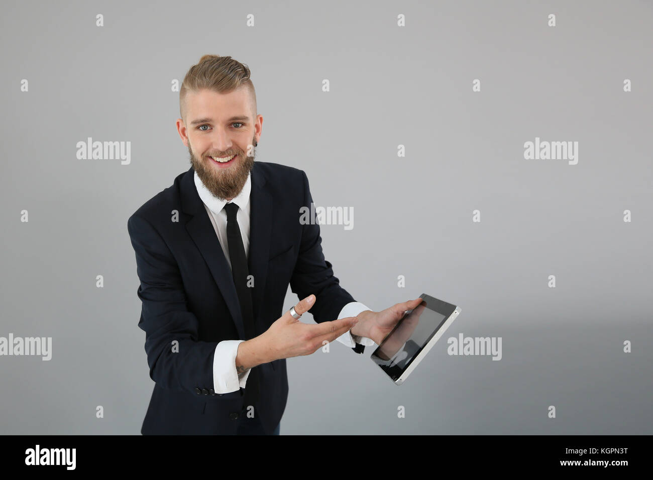 Young businessman showing digital tablet screen Stock Photo - Alamy