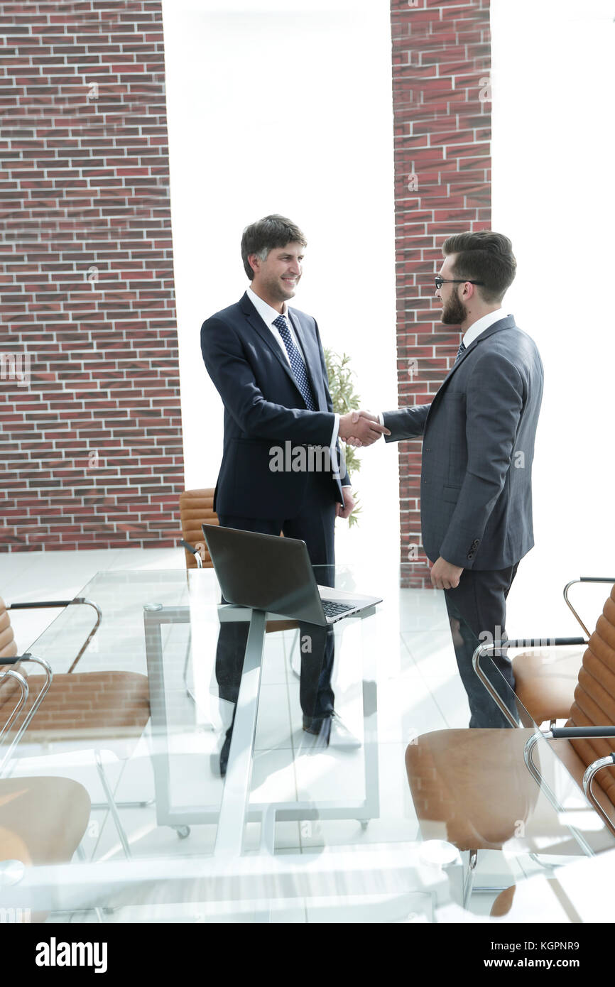 businessmen shaking hands in office building Stock Photo - Alamy