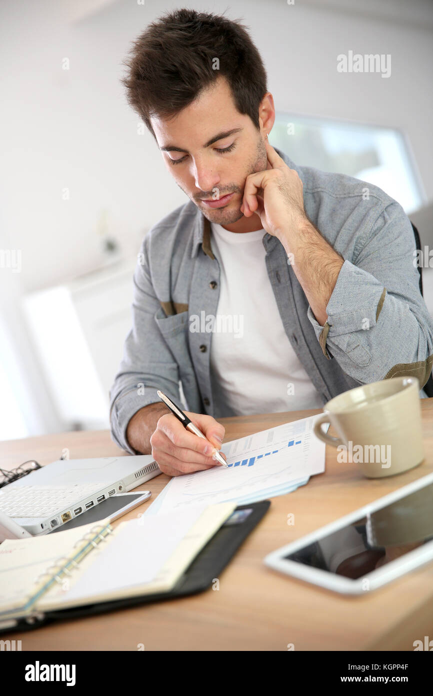 Salesman working from home on budget Stock Photo Alamy