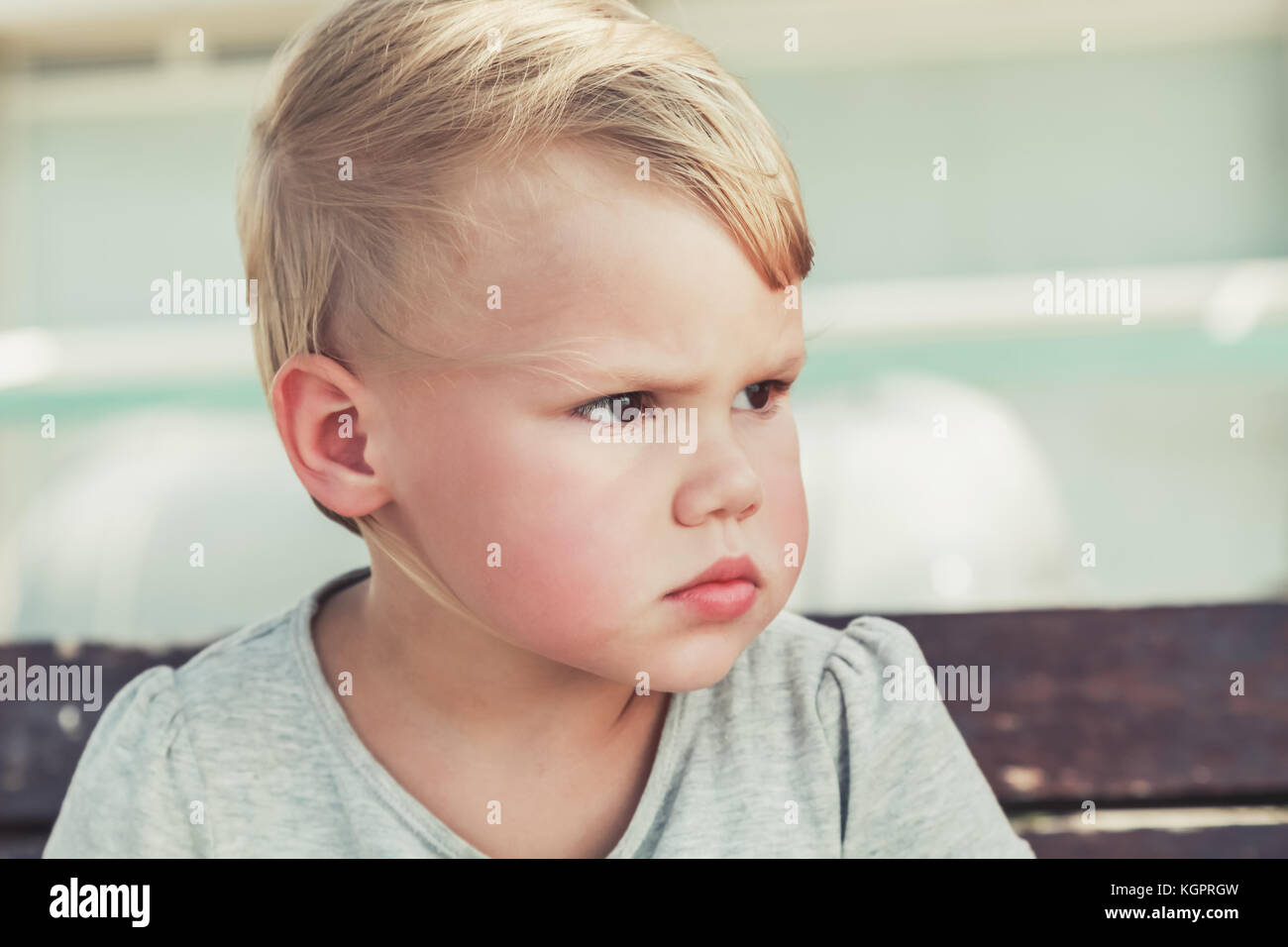 Serious cute Caucasian blond baby girl, outdoor closeup portrait Stock ...