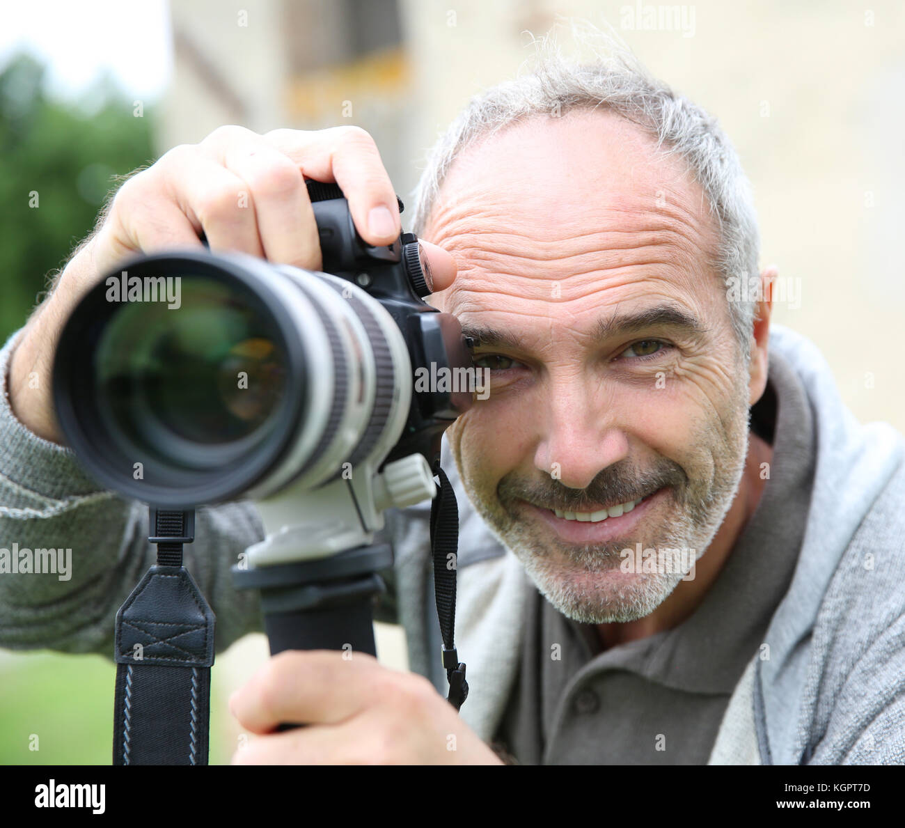 Senior photographer using digital camera Stock Photo - Alamy