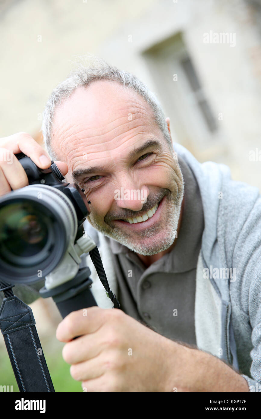 Senior photographer using digital camera Stock Photo - Alamy