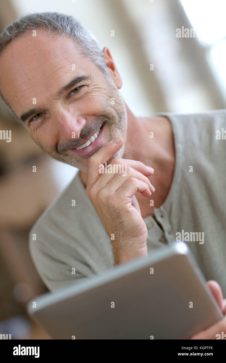 50yearold man using digital tablet Stock Photo Alamy