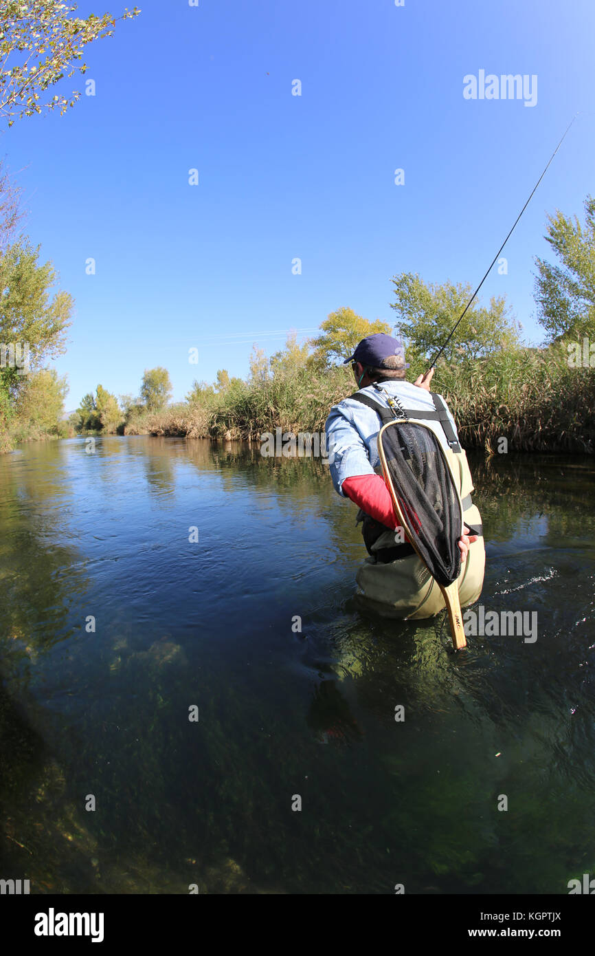 Fly fisherman fishing in low water river Stock Photo Alamy