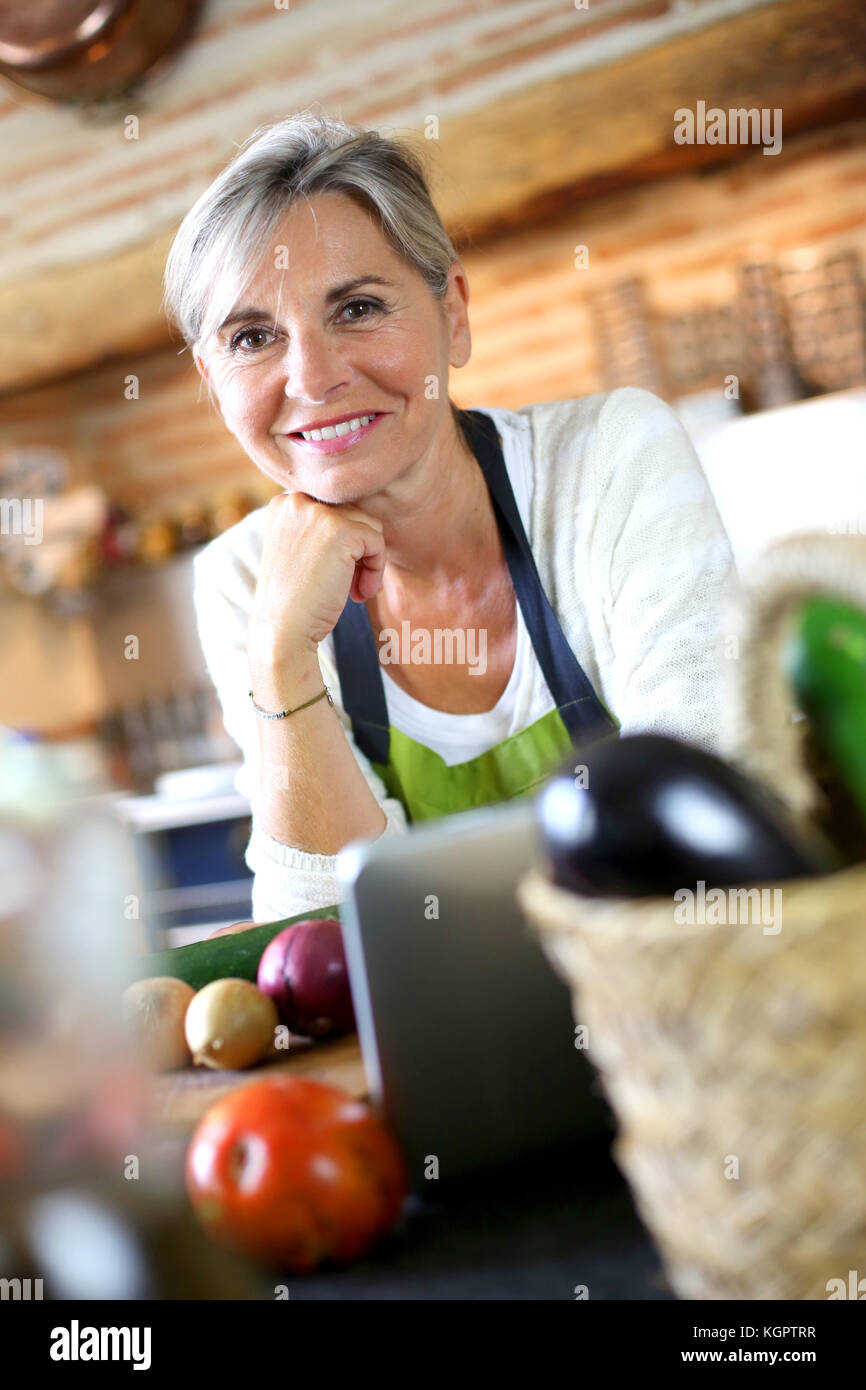 Portrait of senior woman in home kitchen Stock Photo