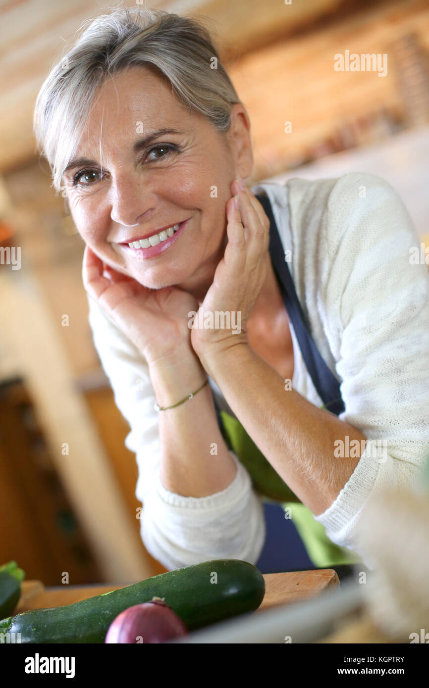 Portrait of senior woman in home kitchen Stock Photo