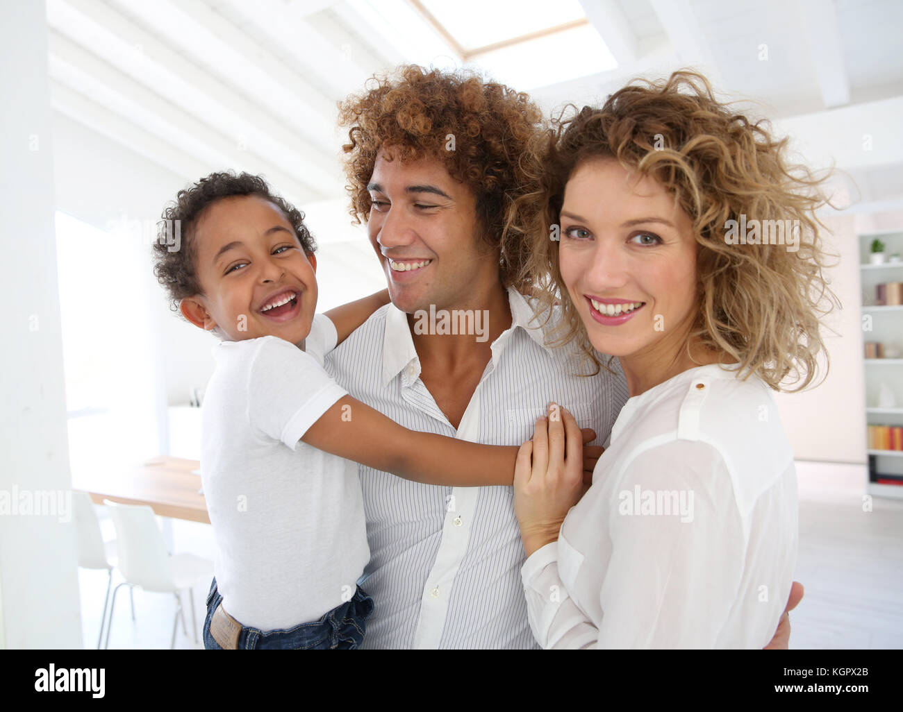 Happy family standing in brand new home Stock Photo - Alamy