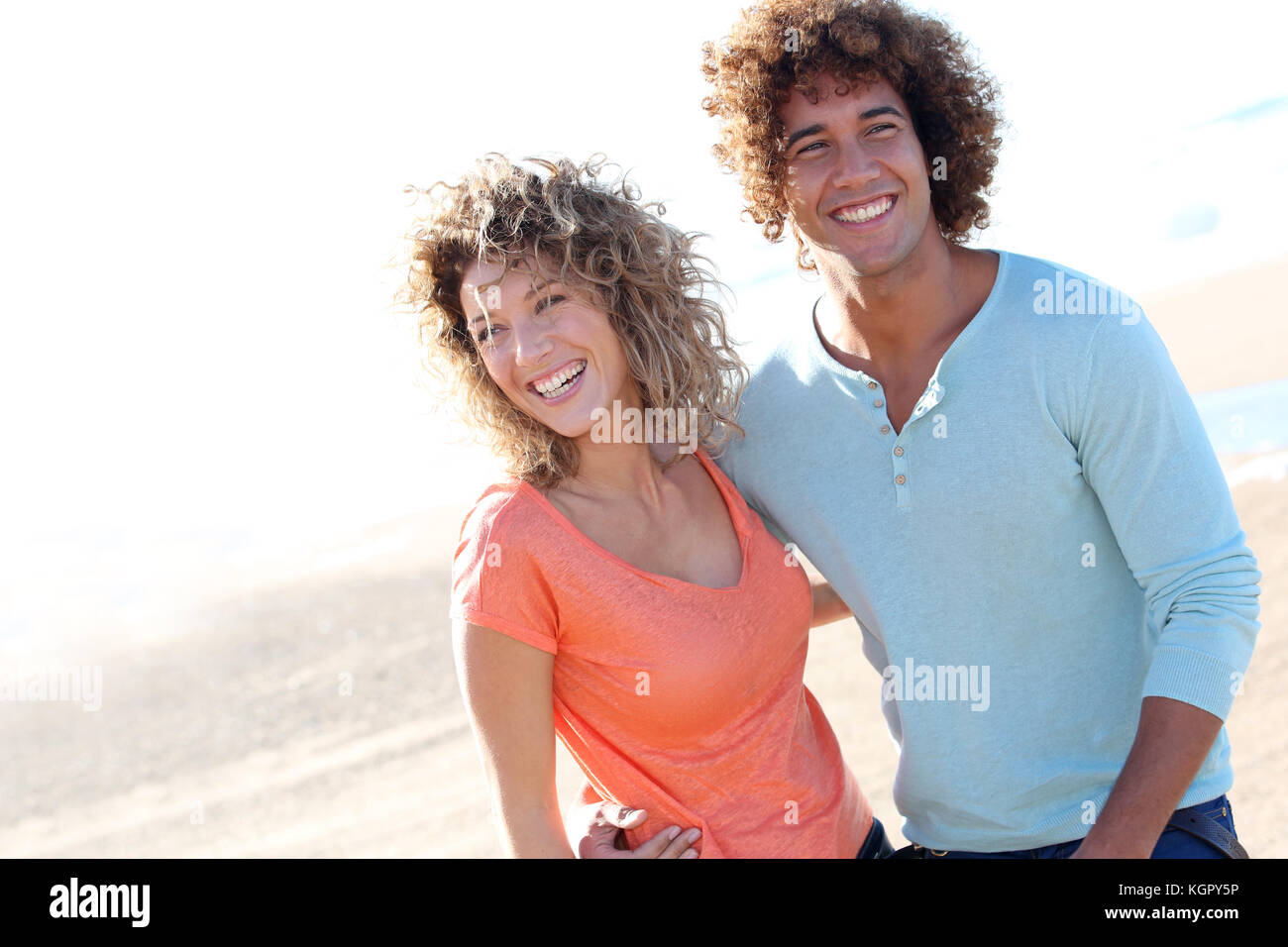 Smiling couple walking on the beach Stock Photo - Alamy
