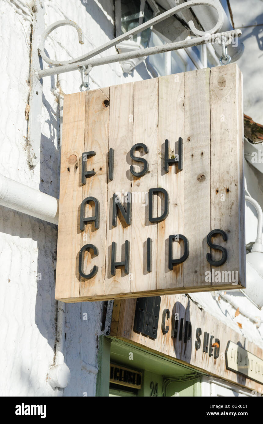 Fish and Chips sign on wooden board hanging above entrance in West Street, Warwick, UK Stock Photo