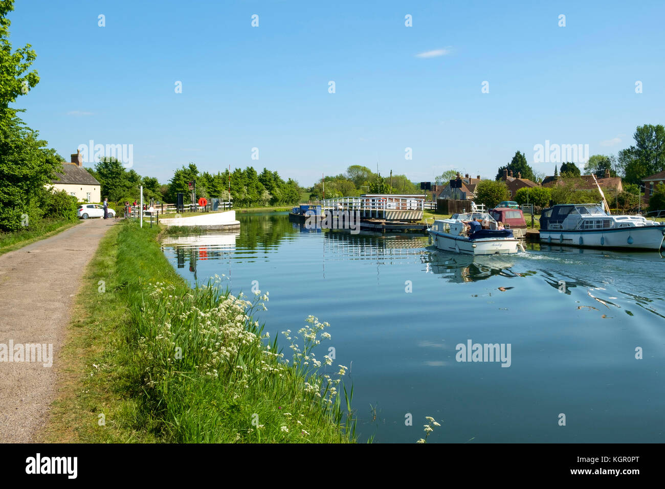 A Small Boat Cruises Towards The Swing Bridge At Purton
