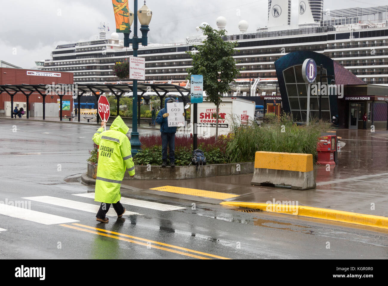 Juneau, Alaska, USA - July 28th, 2017: A crossing guard with the stop sign on his hand working at the cruise terminal in Janeau. Stock Photo