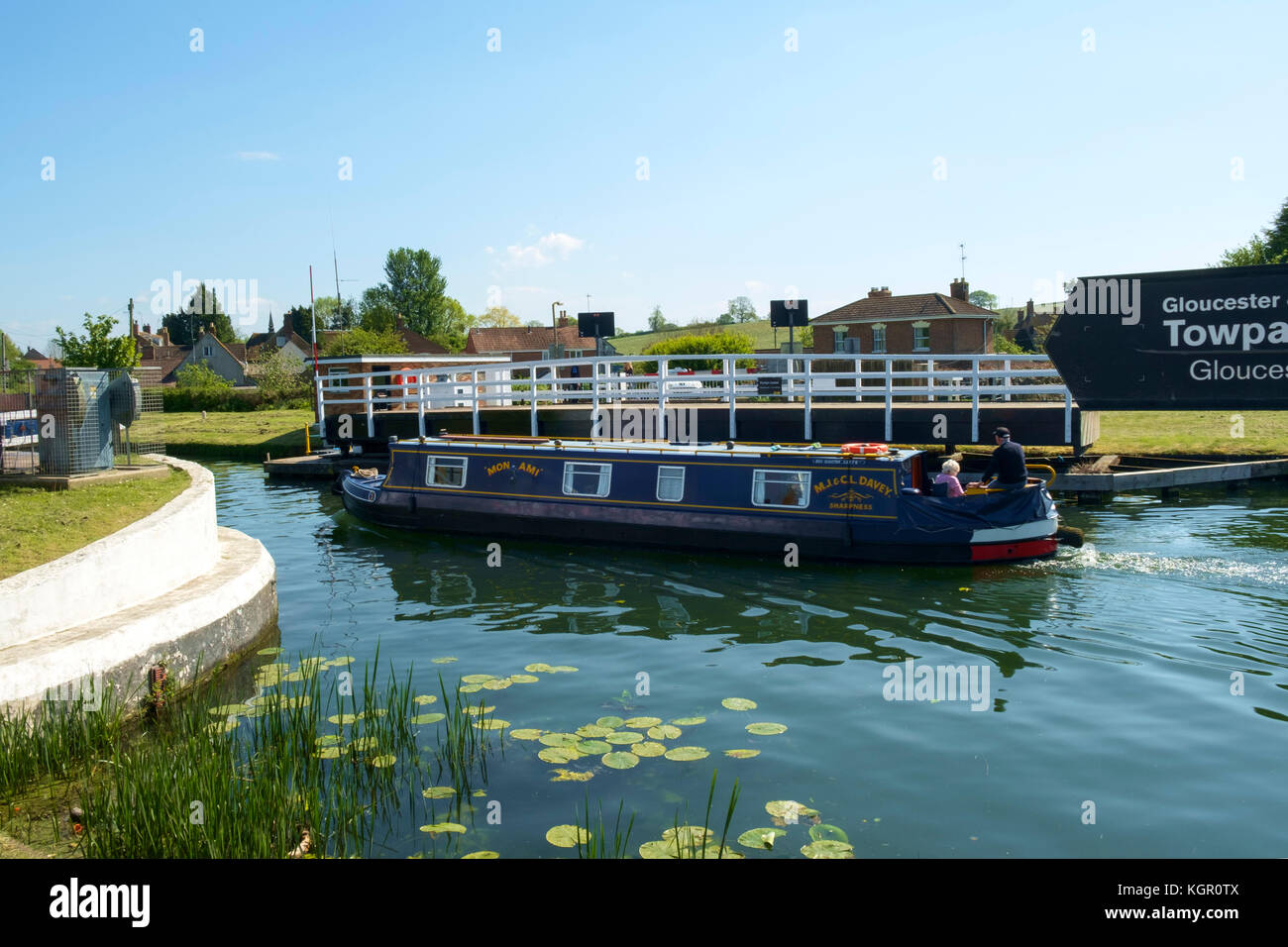 A colourful narrowboat passes through the swing bridge at Purton on the