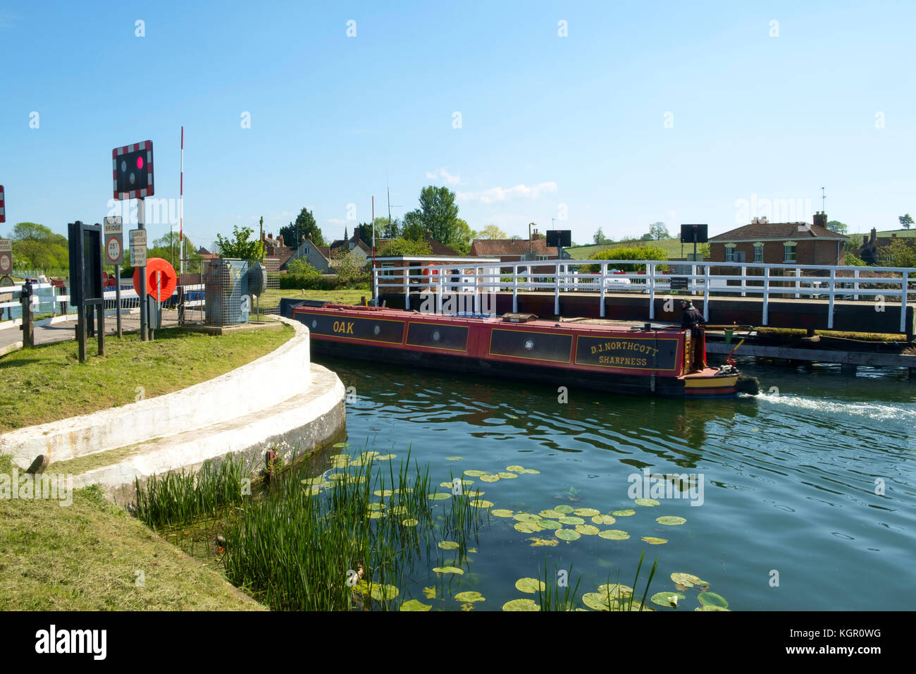 A colourful narrowboat passes through the swing bridge at Purton on the