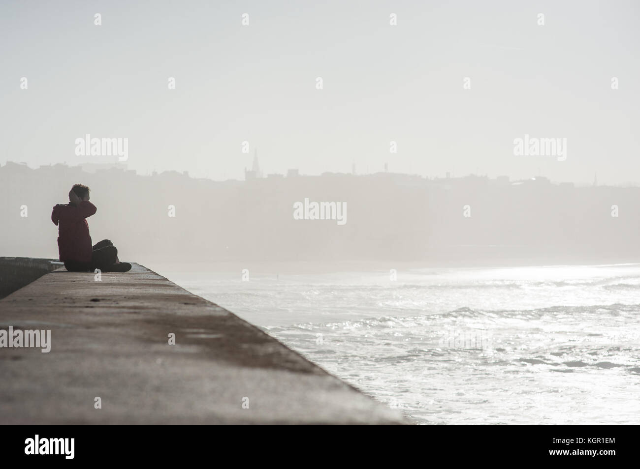 Sitting by the sea Stock Photo - Alamy