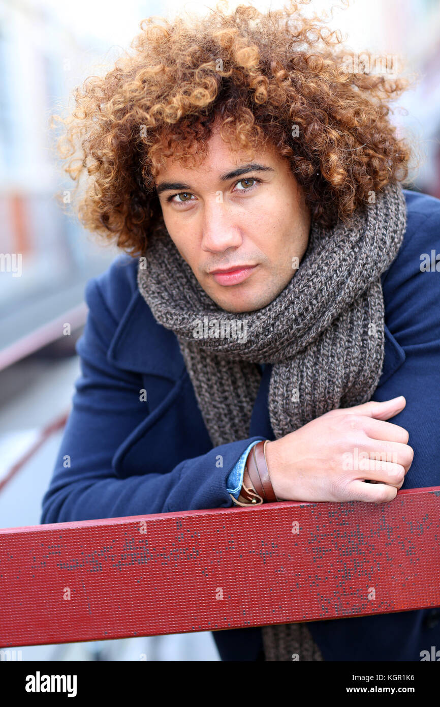 Handsome mixed-raced guy in city street Stock Photo