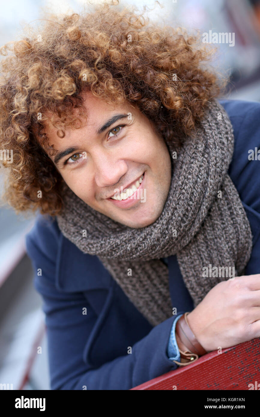 Handsome mixed-raced guy in city street Stock Photo