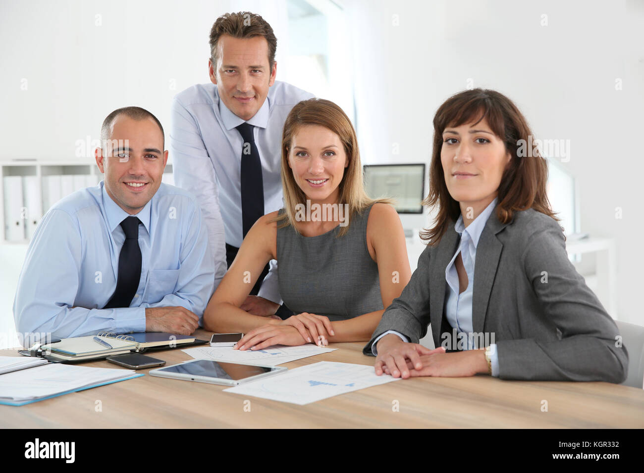 Portrait of business people sitting in office Stock Photo - Alamy