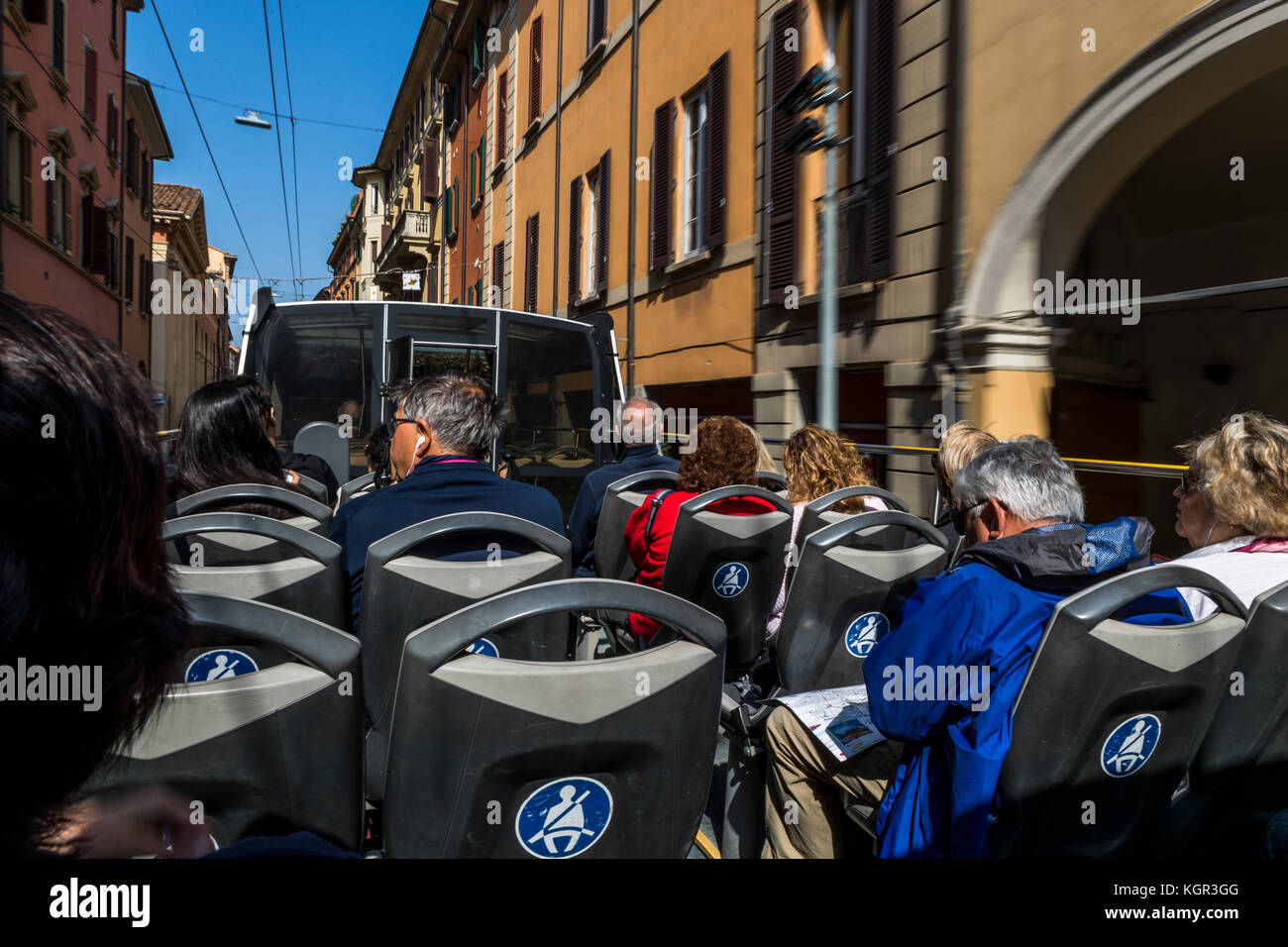 Tourists and visitors take the red bus tour through the city, Bologna